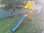Timber cubby house with slide and swings