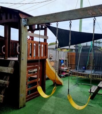Kids playground cubby, slide and swings